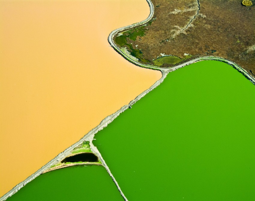 an aerial view of a river with green water