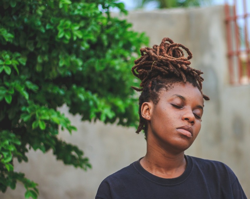 woman wearing black crew neck shirt near green trees