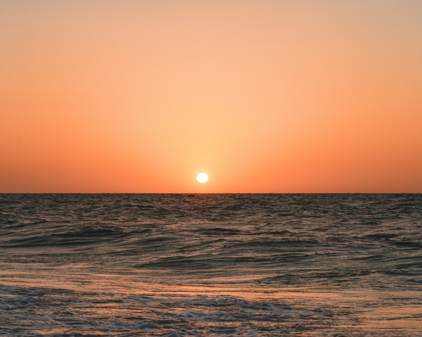 body of water during sunset