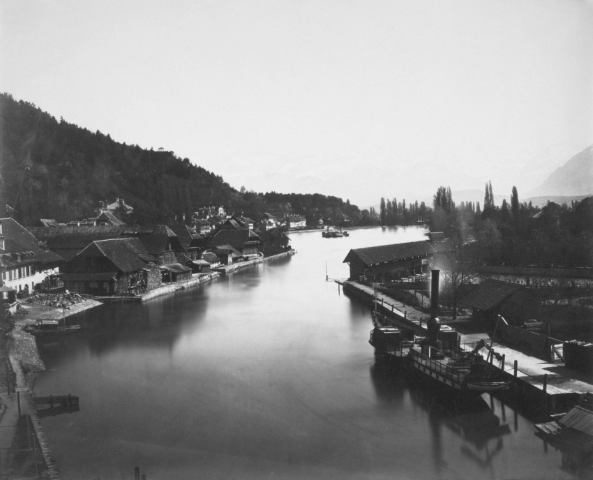 a black and white photo of a river