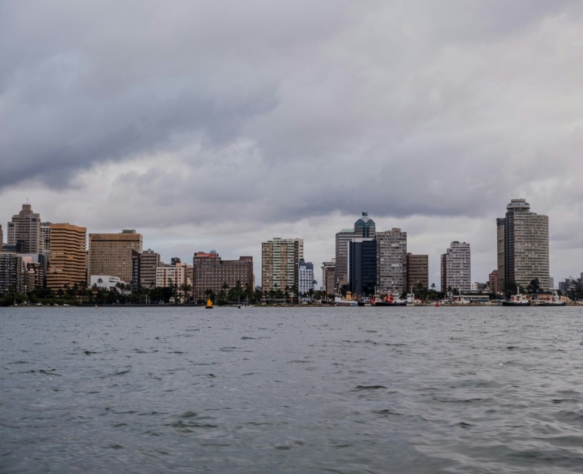 a large body of water with a city in the background