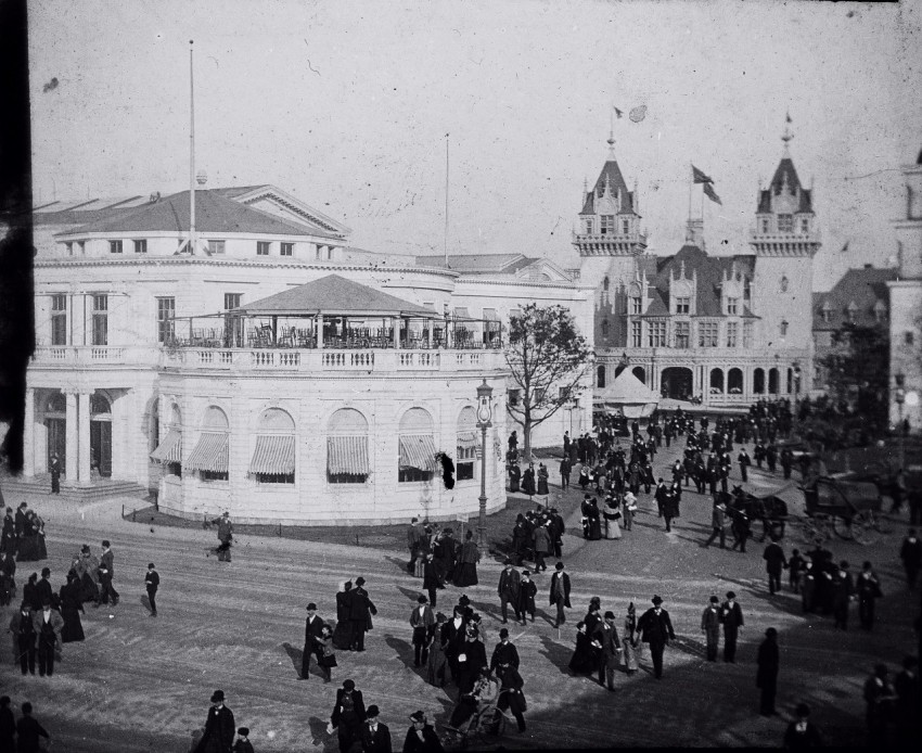 a crowd of people standing around a large building