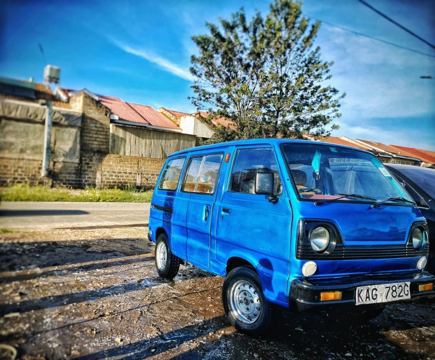 a blue car parked on a road