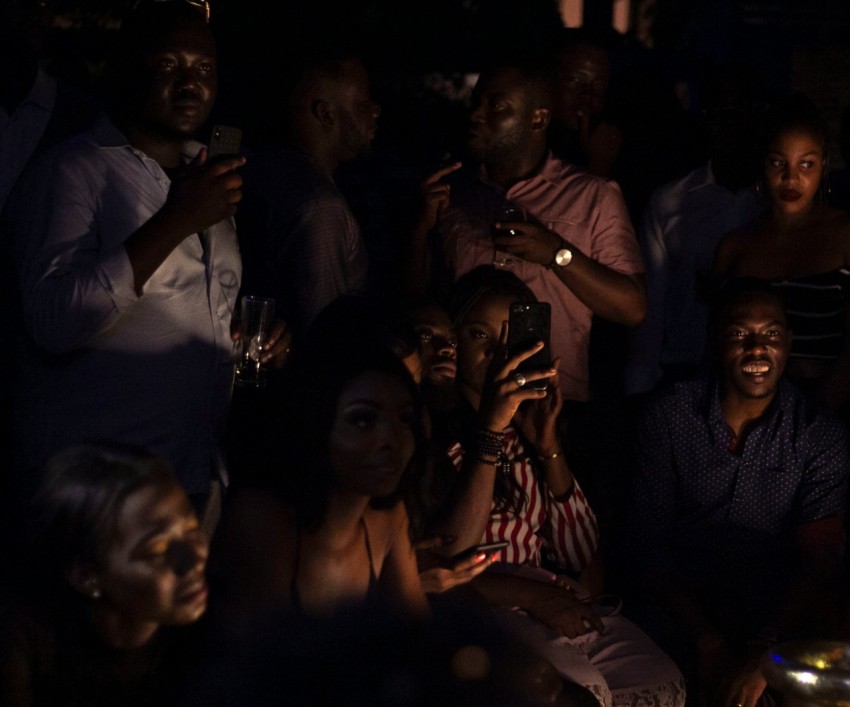 people taking photos on dark room