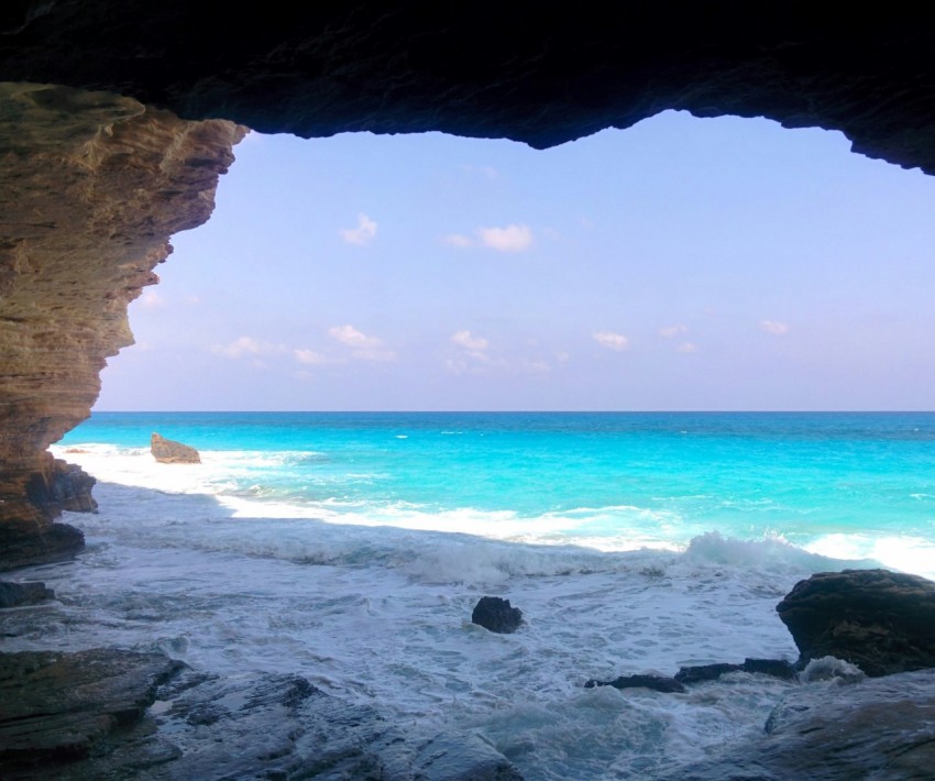 a view of the ocean from inside a cave