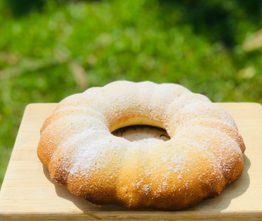 a donut sitting on top of a wooden cutting board