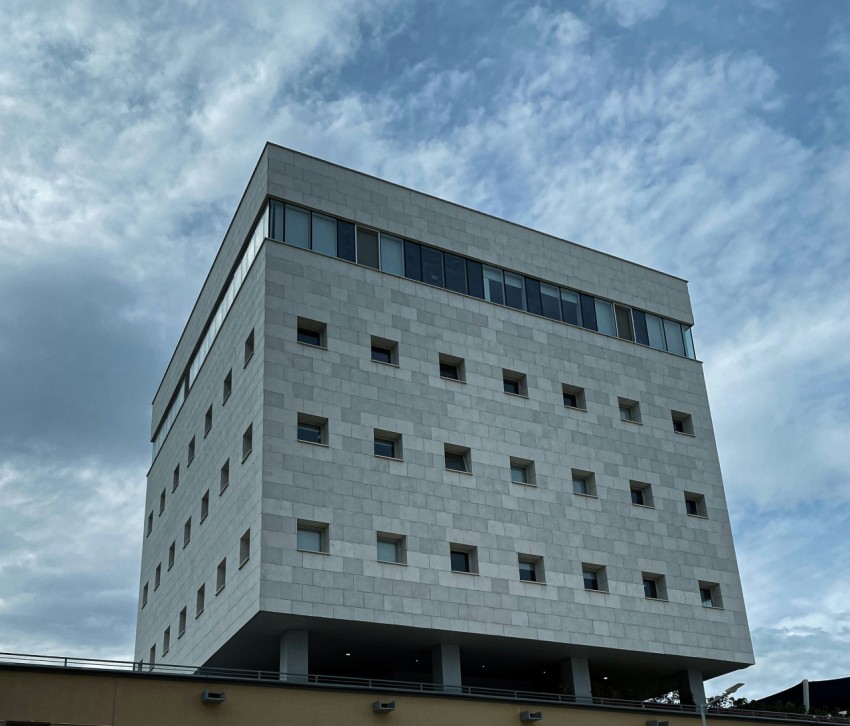 a tall white building with lots of windows