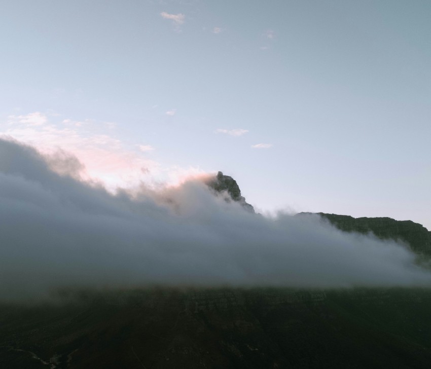 a mountain covered in a layer of fog