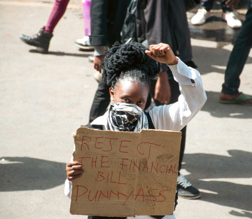 a young girl holding a sign that reads bee bee bee bee bee bee bee bee