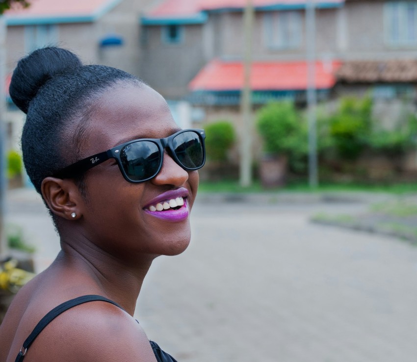 woman wearing black ray ban wayfarer style sunglasses smiling