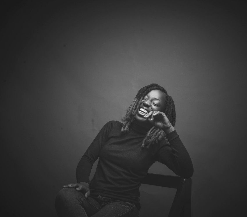 a woman with dreadlocks sitting on a chair