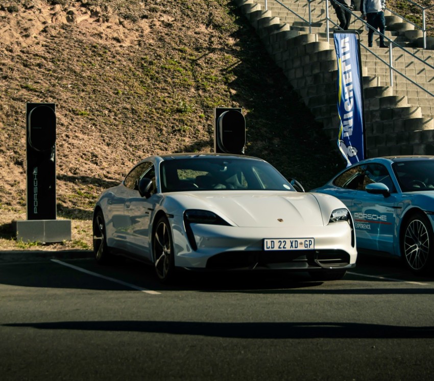 two white sports cars parked next to each other