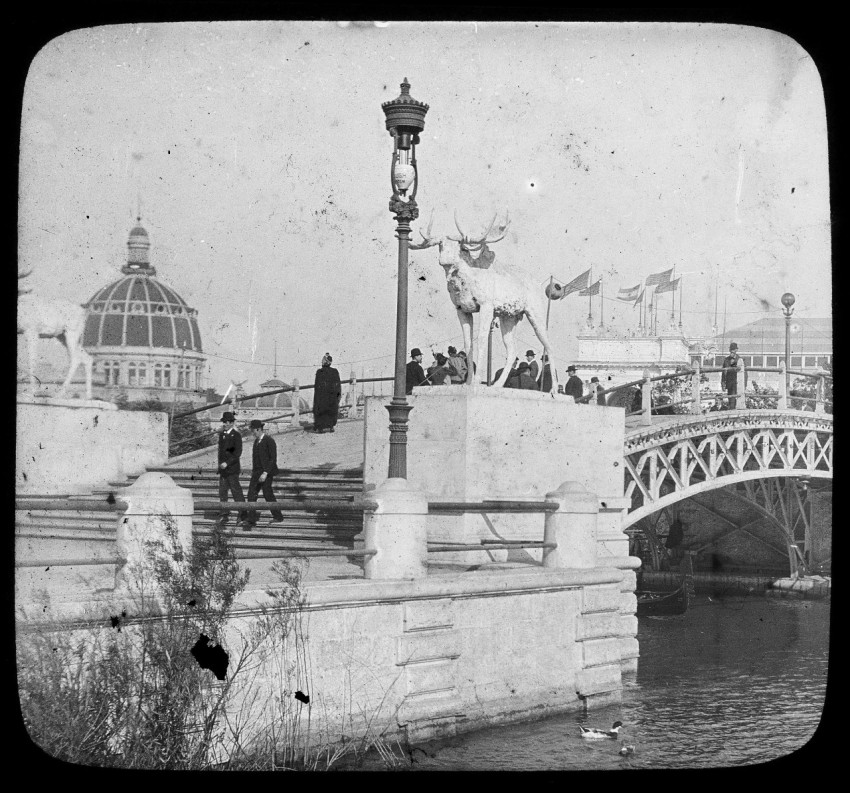 a black and white photo of a bridge and some people