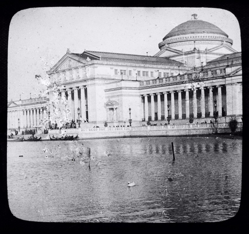 an old photo of a building with a pond in front of it