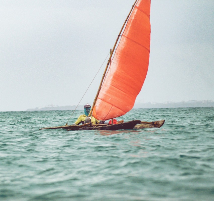 a person riding a sail boat on a body of water