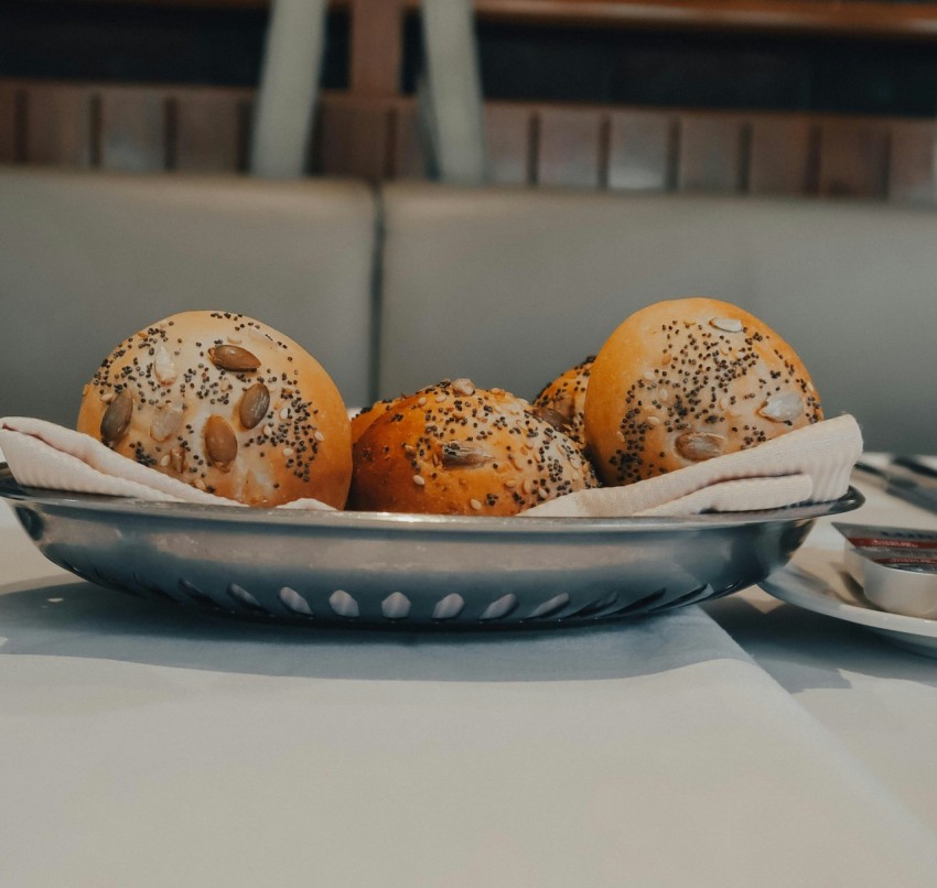 a bowl filled with buns sitting on top of a table