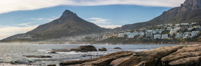 a view of a beach with mountains in the background