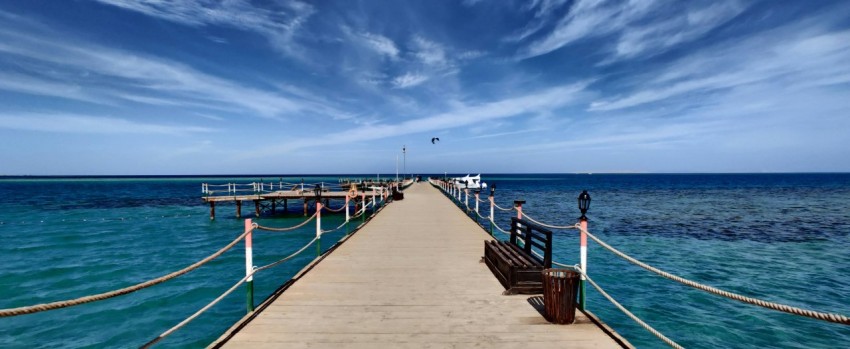 a pier with a bench on the end of it Yk