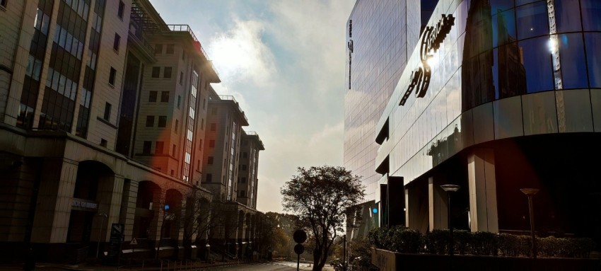 a person walking down a street next to tall buildings