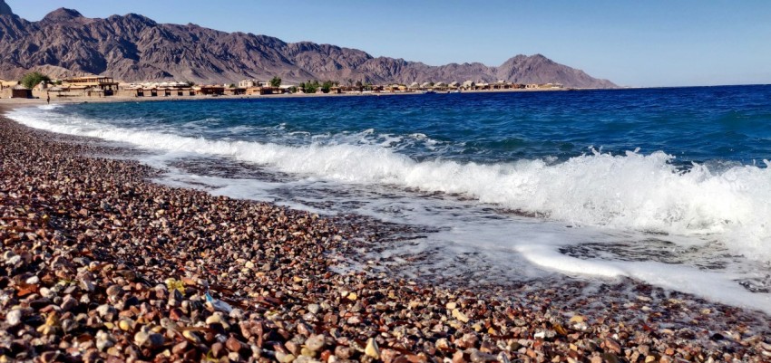 a rocky beach with waves crashing