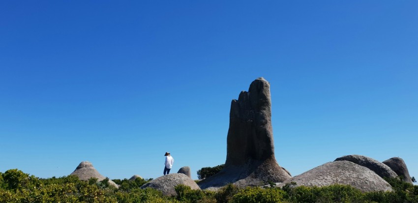 man standing on rock formations