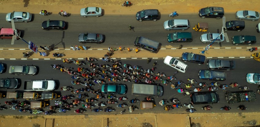 a group of people standing on the side of a road