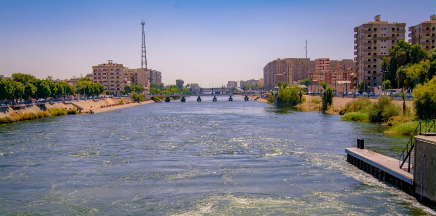 body of water near city buildings during daytime