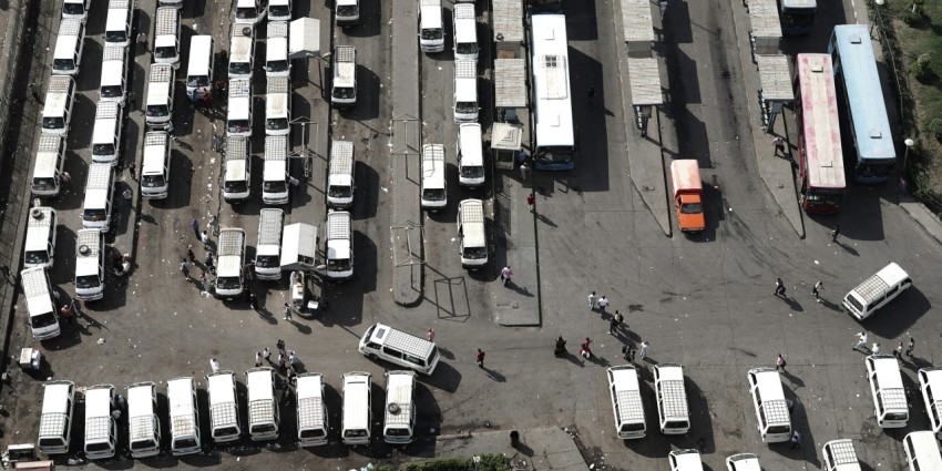 a parking lot filled with lots of white trucks