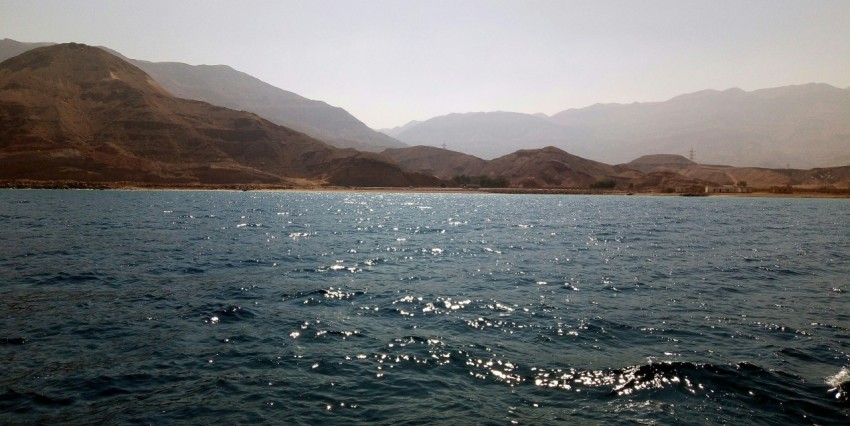 a body of water with mountains in the background