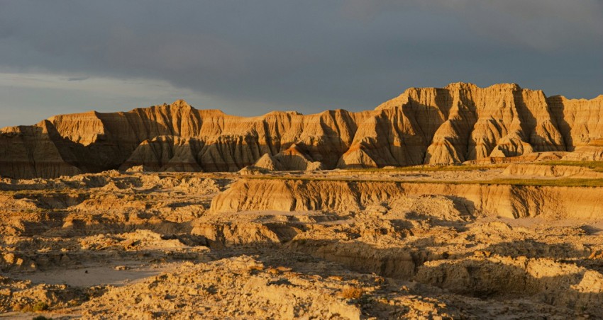 a desert landscape with a mountain range in the background