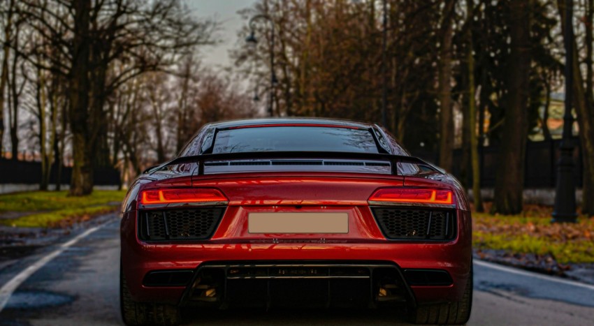 a red sports car parked on the side of the road HjIzwYc