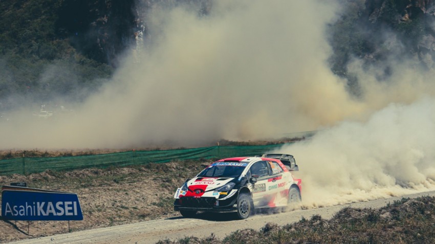 a rally car driving down a dirt road