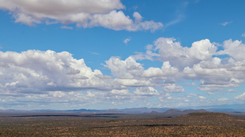 a view of a mountain range with clouds in the sky