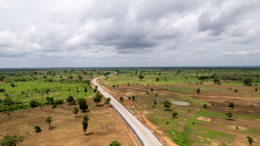 an aerial view of a road in the middle of a field