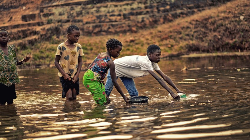 a group of children playing in a body of water