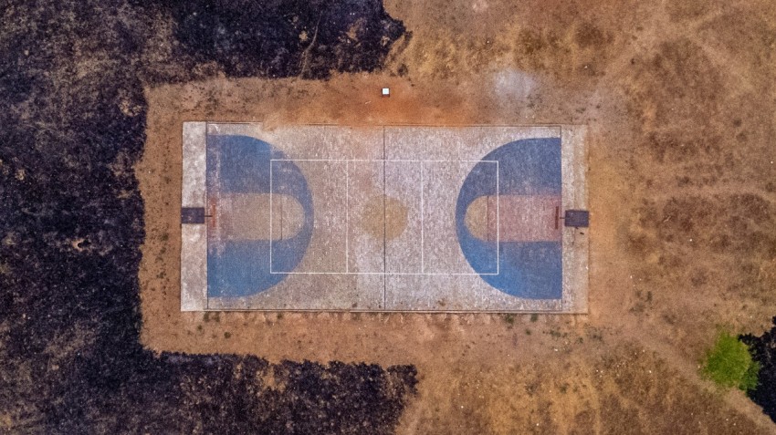 an aerial view of a tennis court in the middle of nowhere