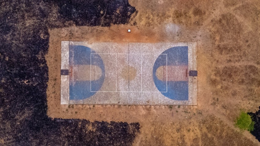an aerial view of a tennis court in the middle of nowhere