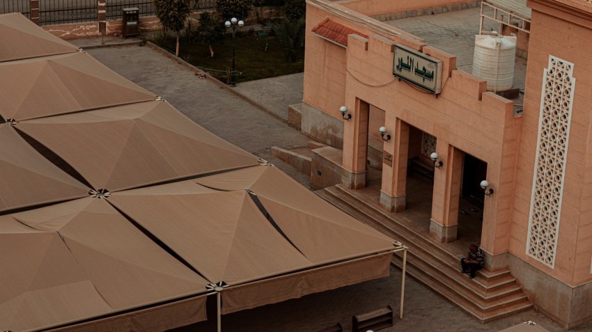 an overhead view of a building with a large umbrella