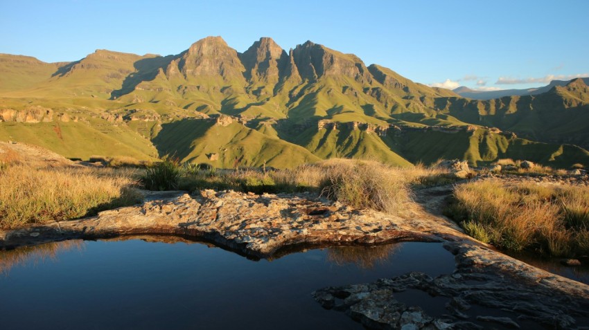 body of water and mountains during day