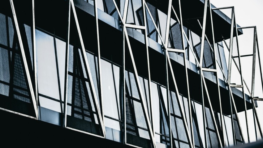 a tall building with lots of windows next to a street