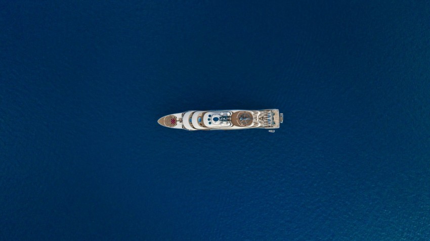 white and blue space ship on blue body of water