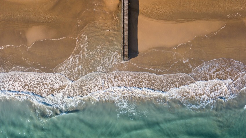 aerial photography of brown wooden dock beside sea R71nn