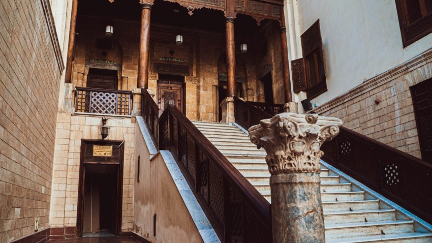 a staircase in a building with a stone column