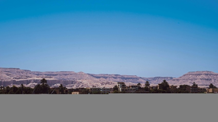 a body of water with a mountain in the background