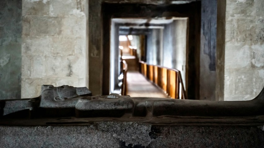 a long hallway with a bench in the middle of it