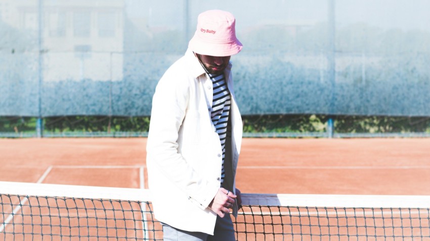 a person in a white suit holding a tennis racket