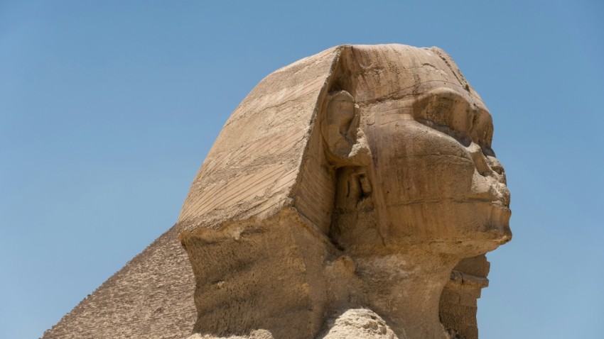 a large statue of a sphinx in front of a blue sky