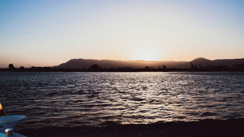 a body of water with hills in the background