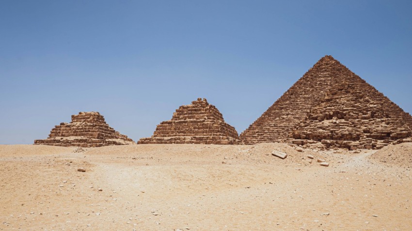 a group of pyramids in a desert