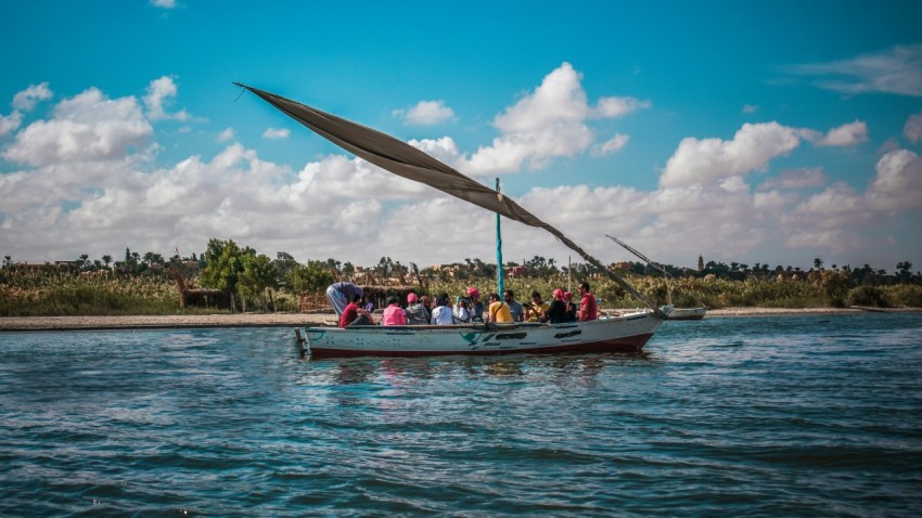 a group of people riding on the back of a boat